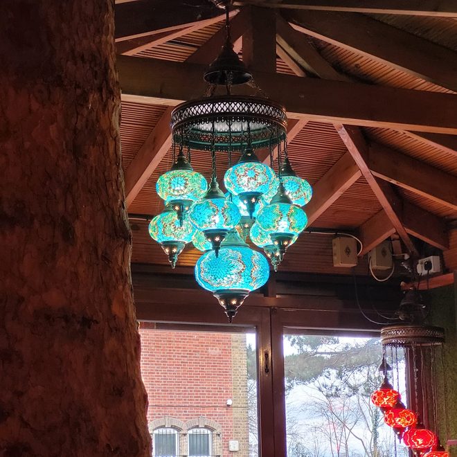 Turquoise Turkish mosaic pendant lamp under the timber-beamed conservatory roof