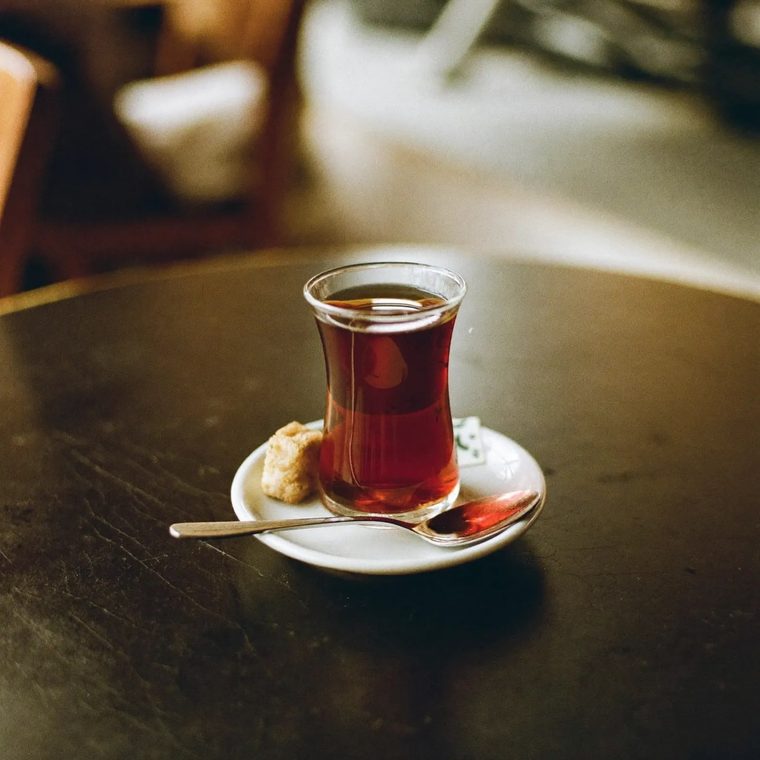 A tulip glass of Turkish tea on a saucer